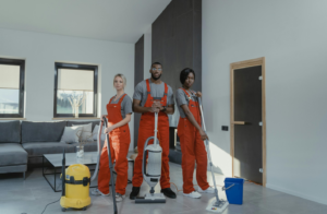 people standing with cleaning equipment