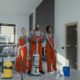 people standing with cleaning equipment