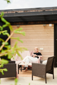 A woman sitting on a clean patio after a pressure washing service.