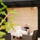 A woman sitting on a clean patio after a pressure washing service.