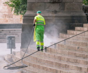 A power washing expert removing dirt and grime.