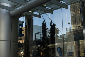 two people cleaning the exterior glass