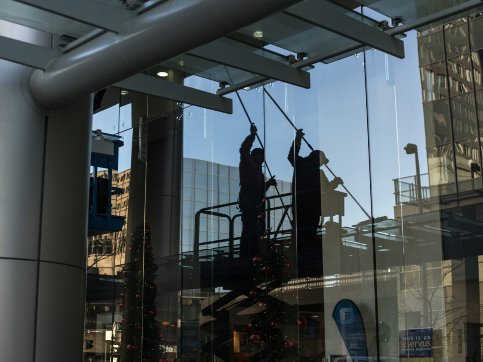 two people cleaning the exterior glass