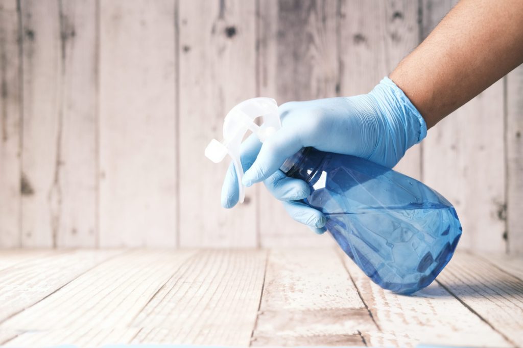 a person holding a spray bottle