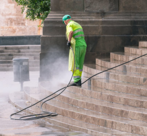 a person pressure washing stairs